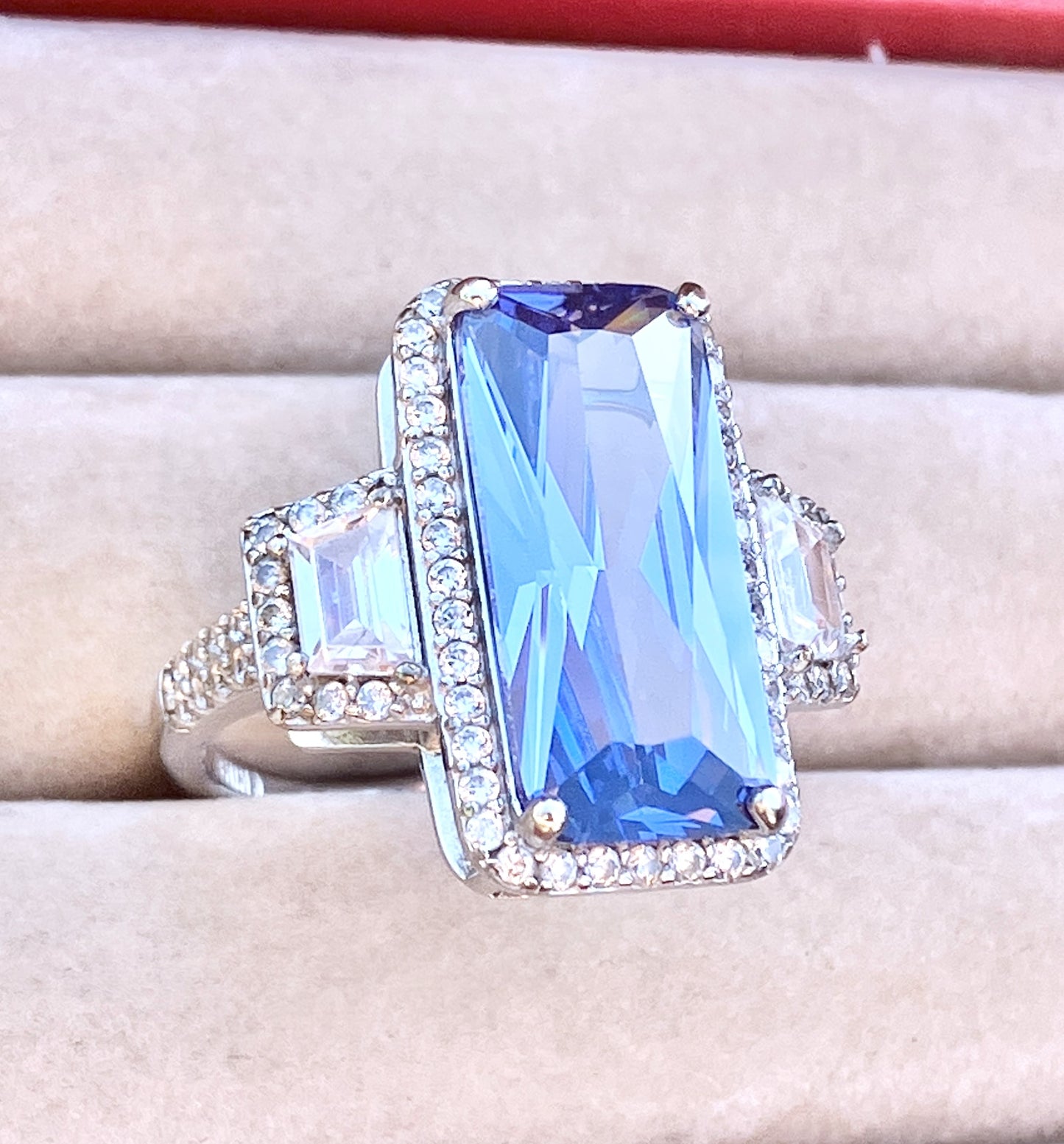 Periwinkle “Sapphire” in “Diamond” Halo with Trapezoid Cut “Diamond” Accents