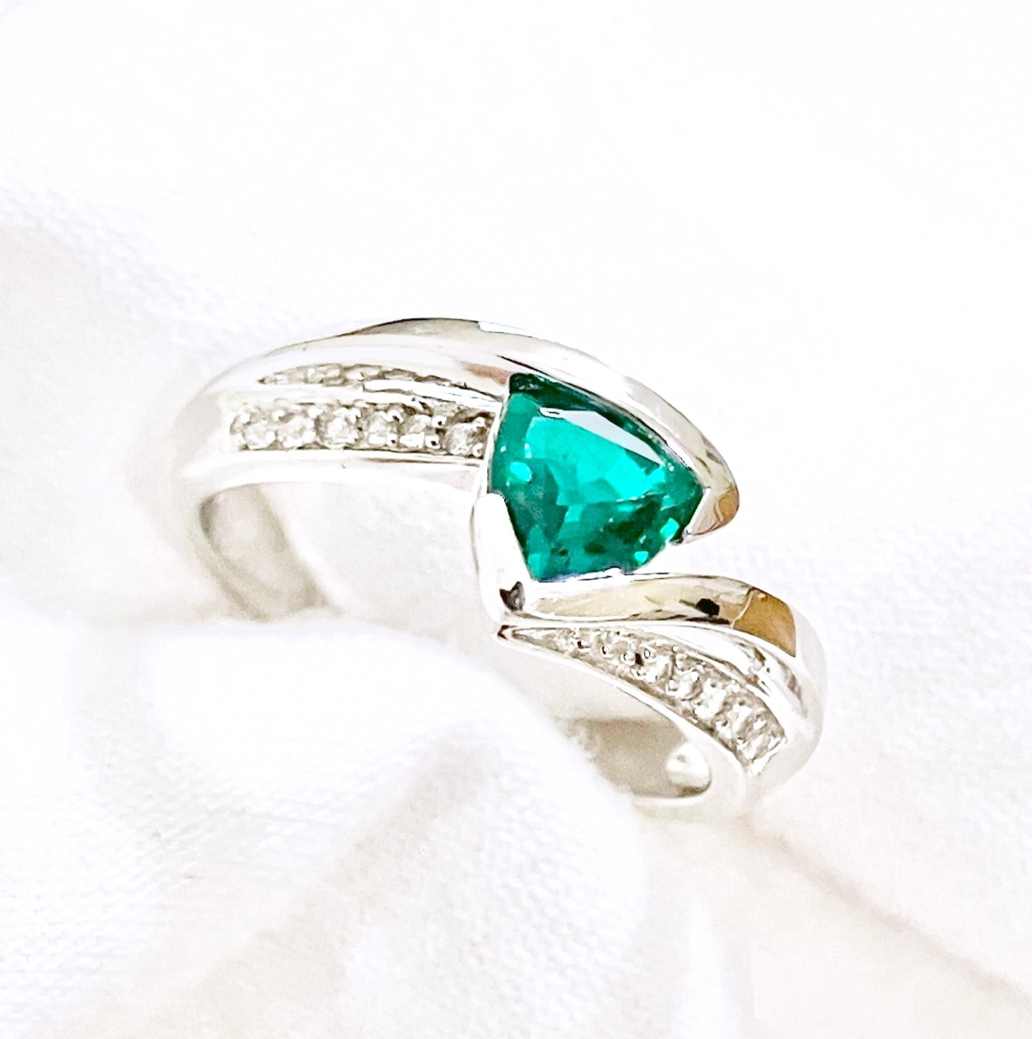 Triangular Brilliant Cut “Emerald” in Curved Bypass Shank with “Diamond” Accents Ring