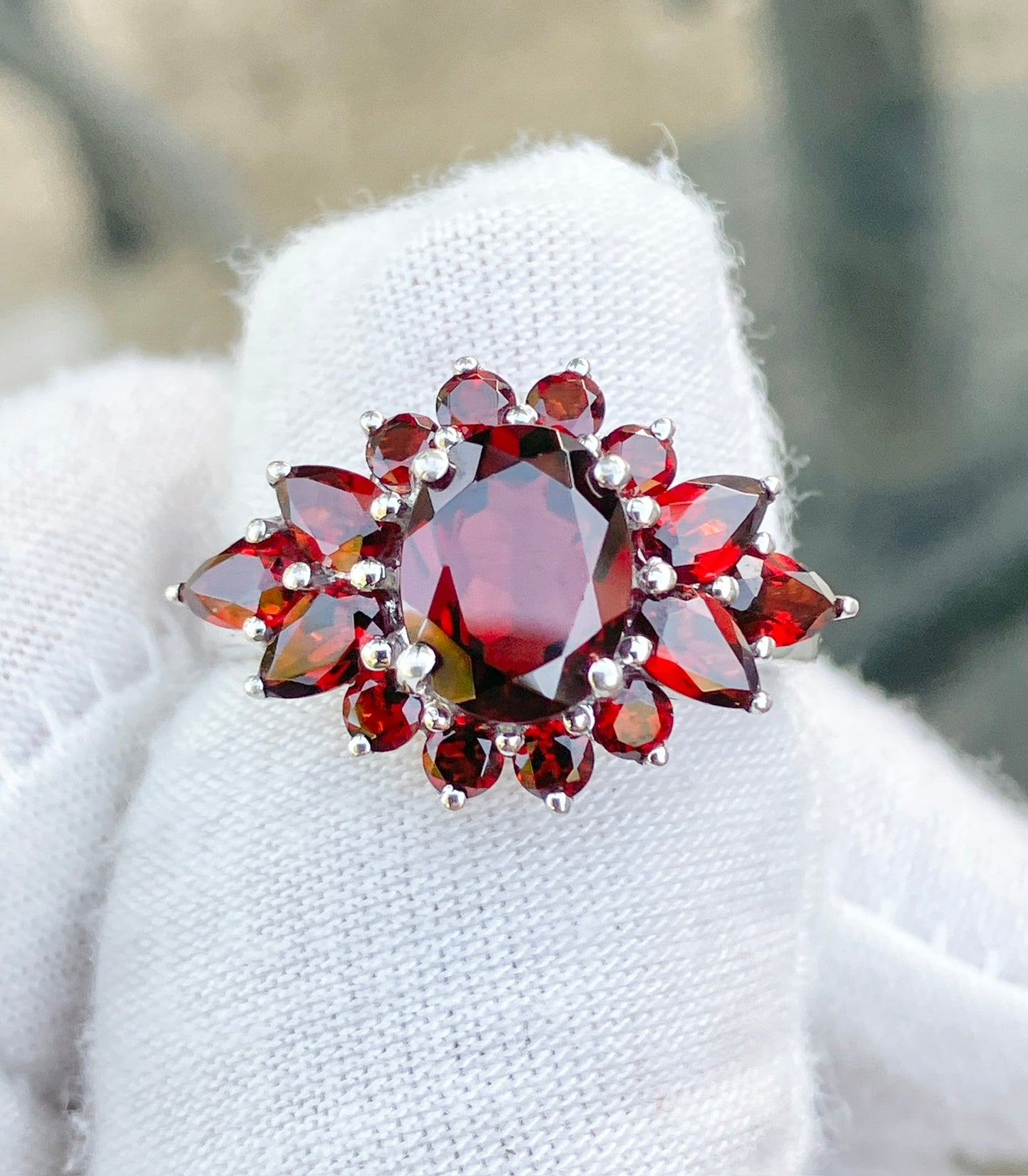 Oval Cut Garnet in a Pear and Round Cut Garnet Halo Ring