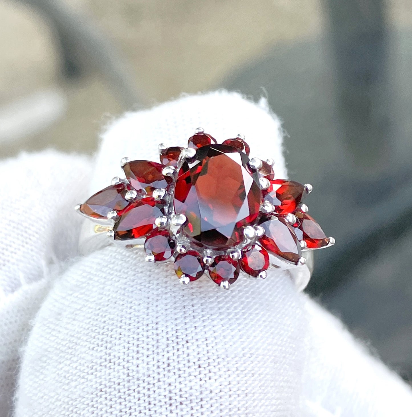 Oval Cut Garnet in a Pear and Round Cut Garnet Halo Ring