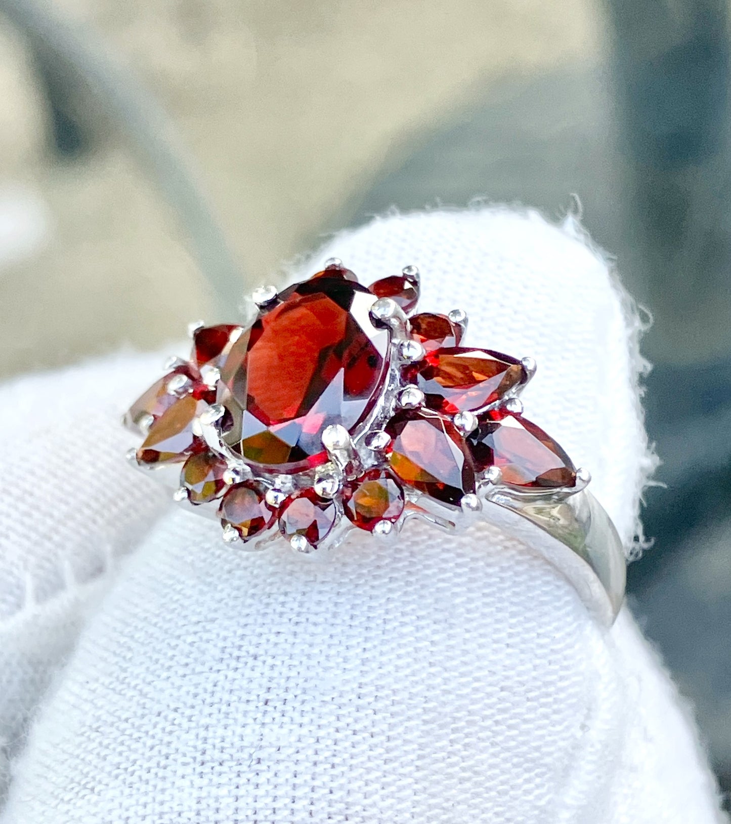 Oval Cut Garnet in a Pear and Round Cut Garnet Halo Ring