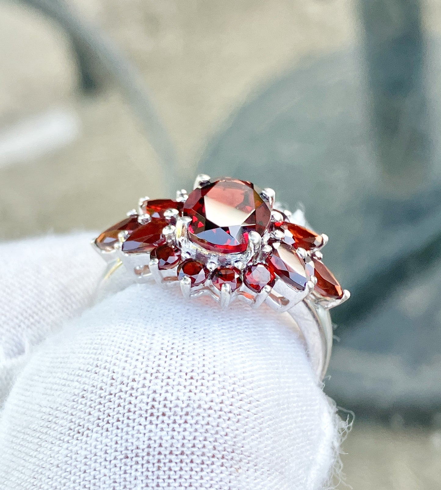 Oval Cut Garnet in a Pear and Round Cut Garnet Halo Ring