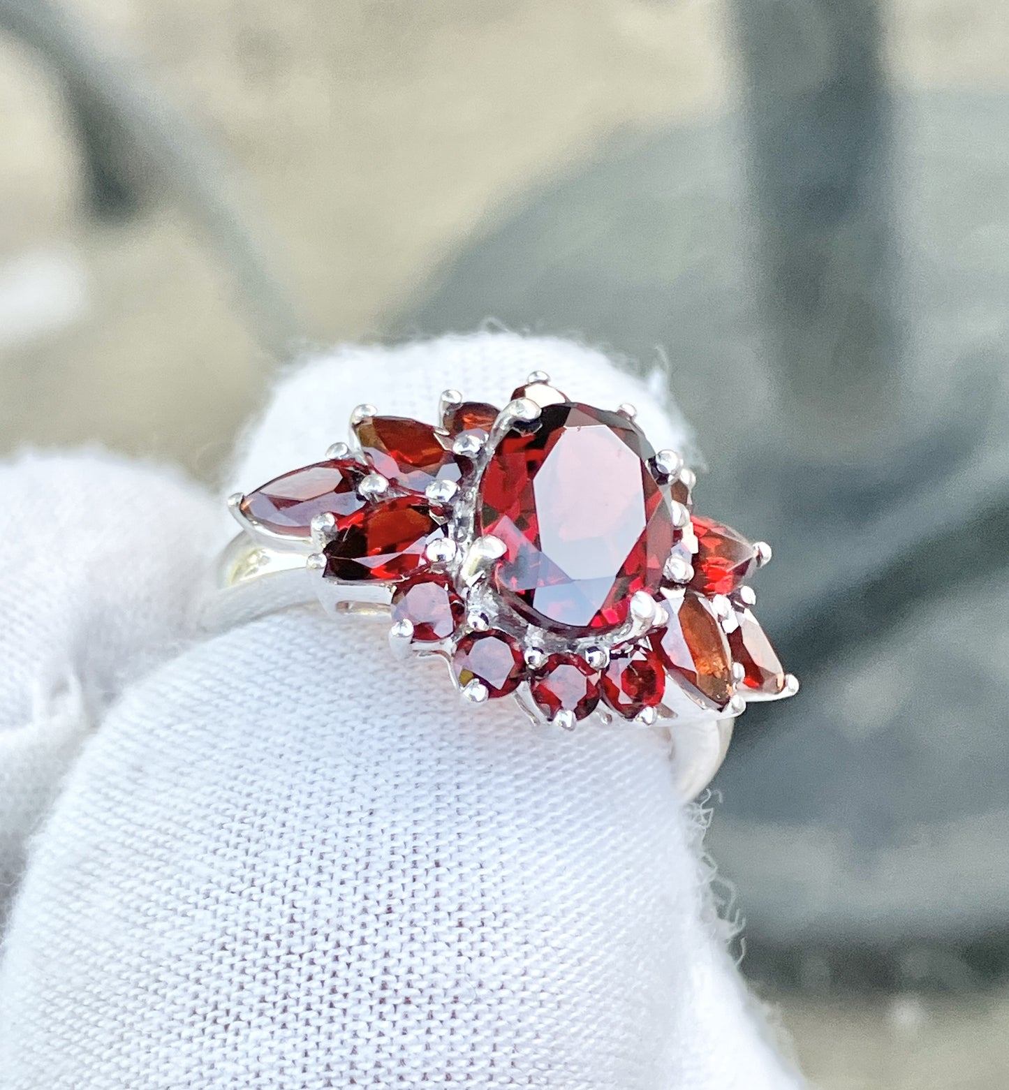 Oval Cut Garnet in a Pear and Round Cut Garnet Halo Ring