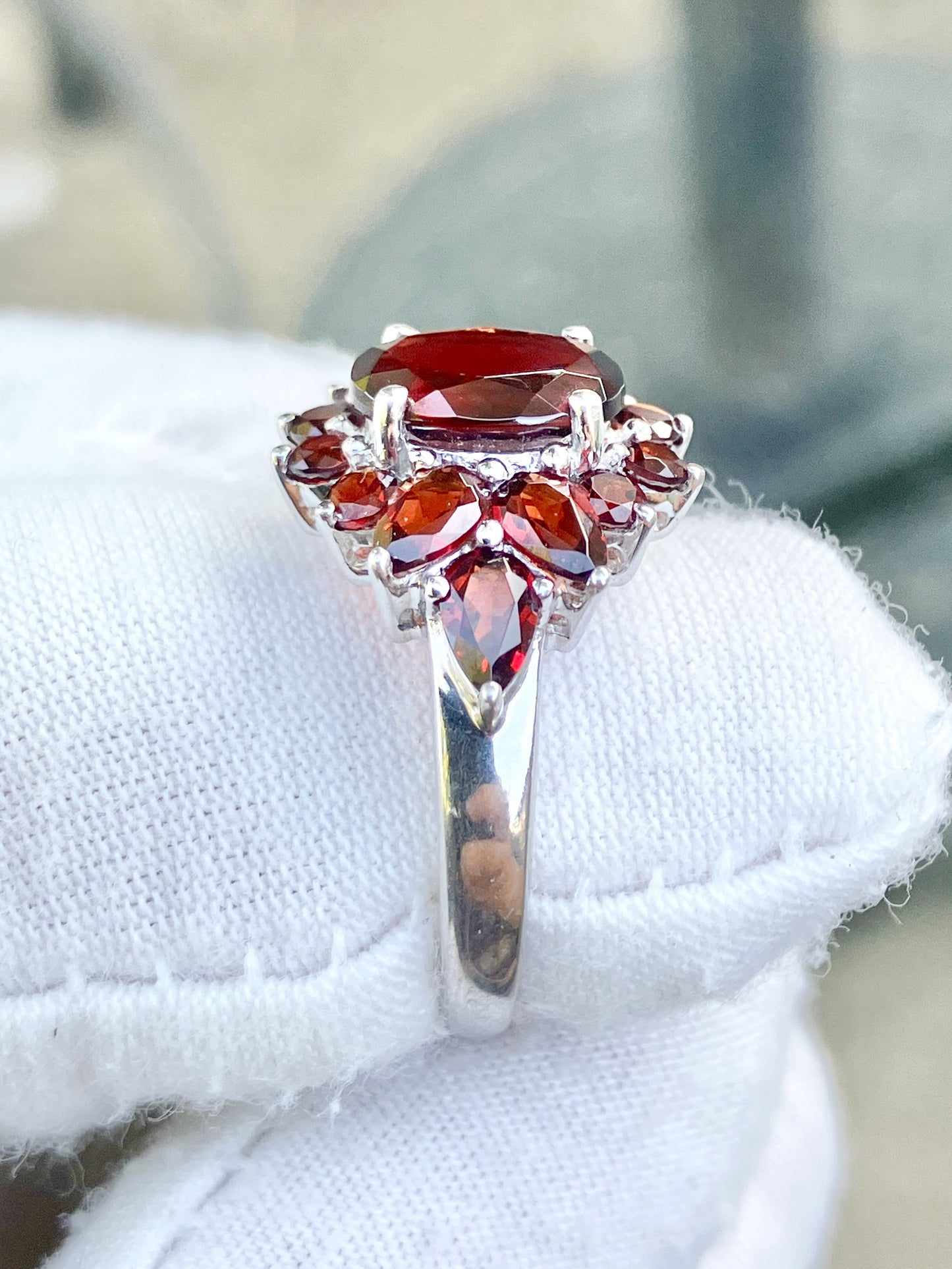 Oval Cut Garnet in a Pear and Round Cut Garnet Halo Ring