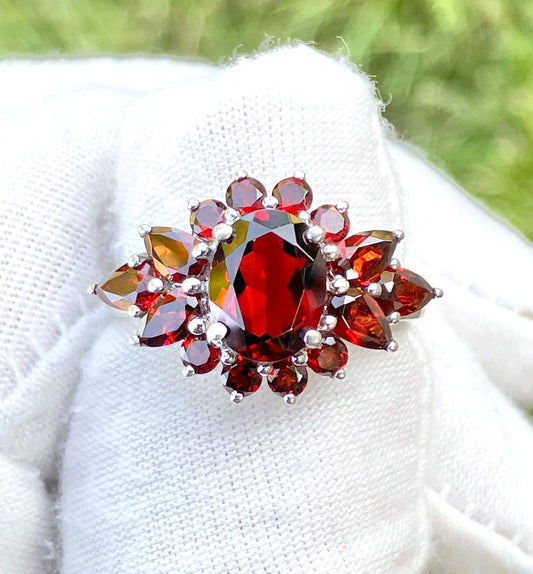 Oval Cut Garnet in a Pear and Round Cut Garnet Halo Ring