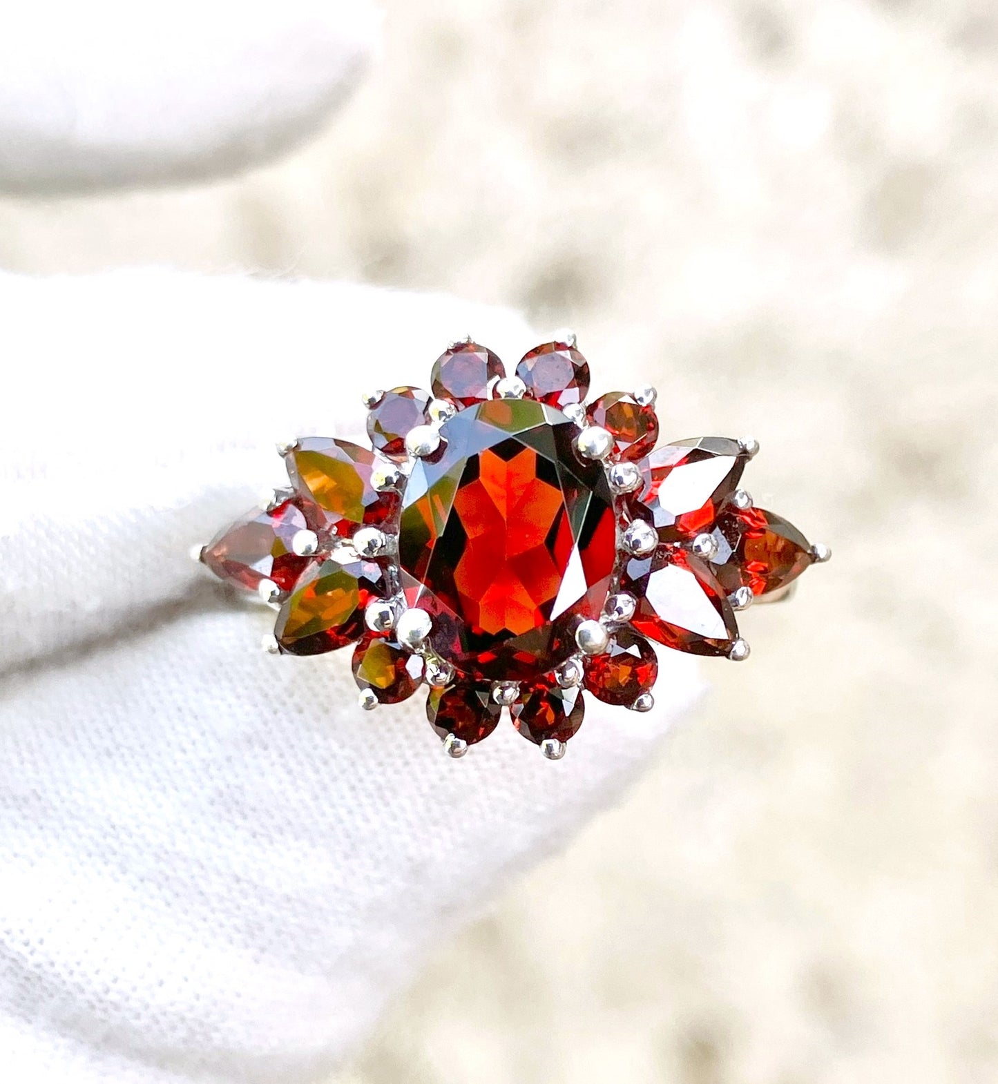 Oval Cut Garnet in a Pear and Round Cut Garnet Halo Ring