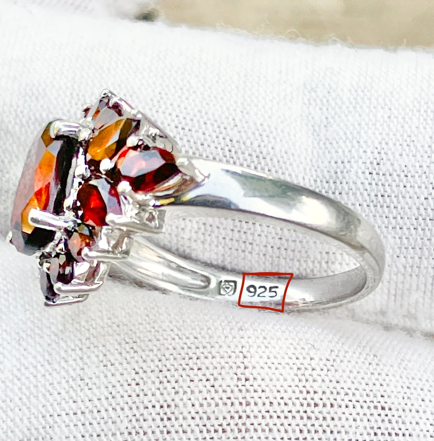 Oval Cut Garnet in a Pear and Round Cut Garnet Halo Ring