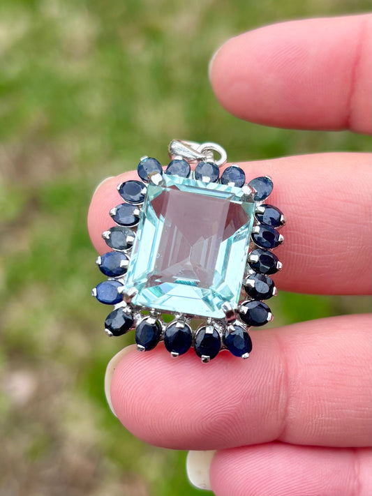 Emerald Cut “Aquamarine” CZ in a Natural Sapphire Halo Pendant