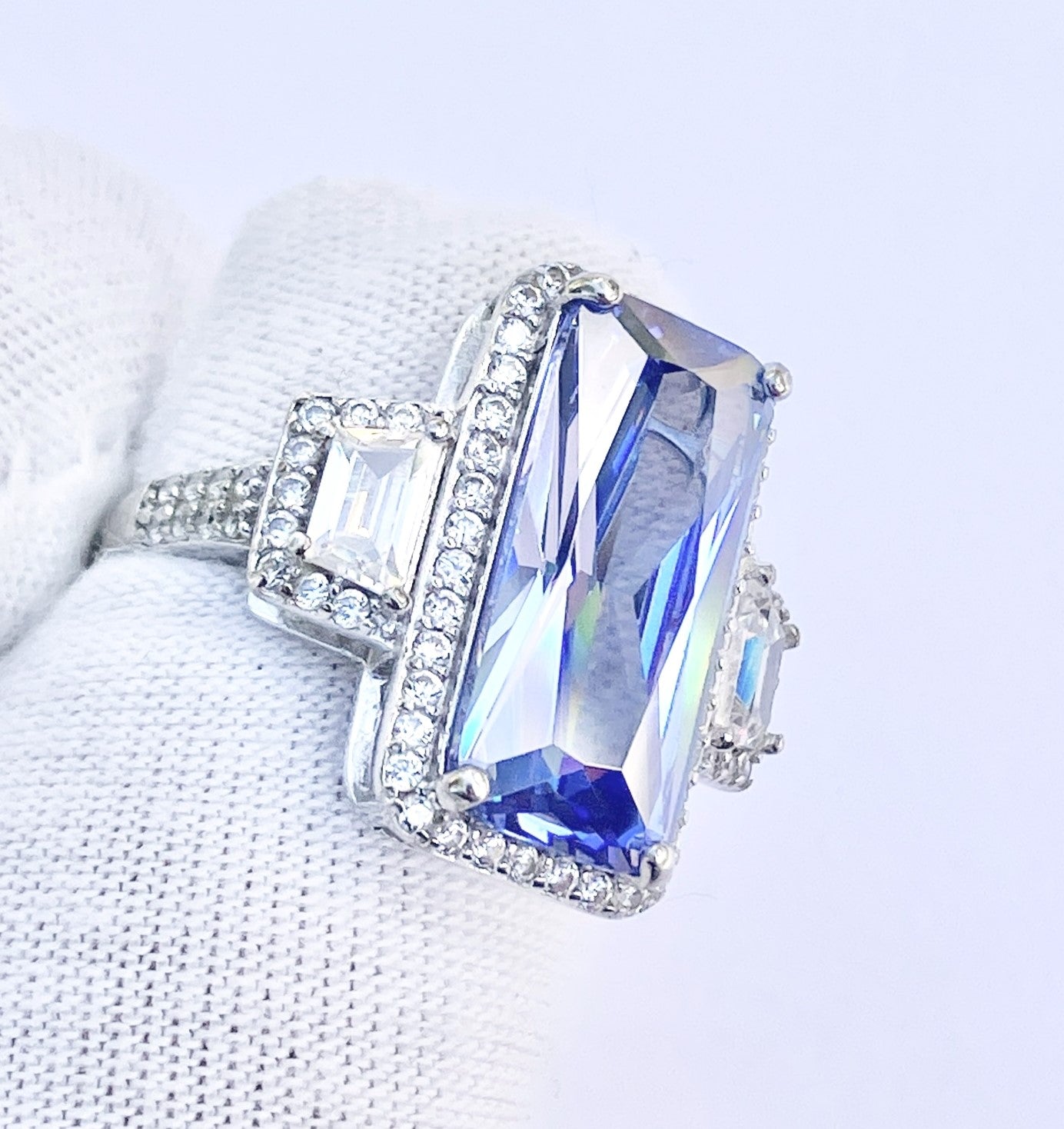 Periwinkle “Sapphire” in “Diamond” Halo with Trapezoid Cut “Diamond” Accents