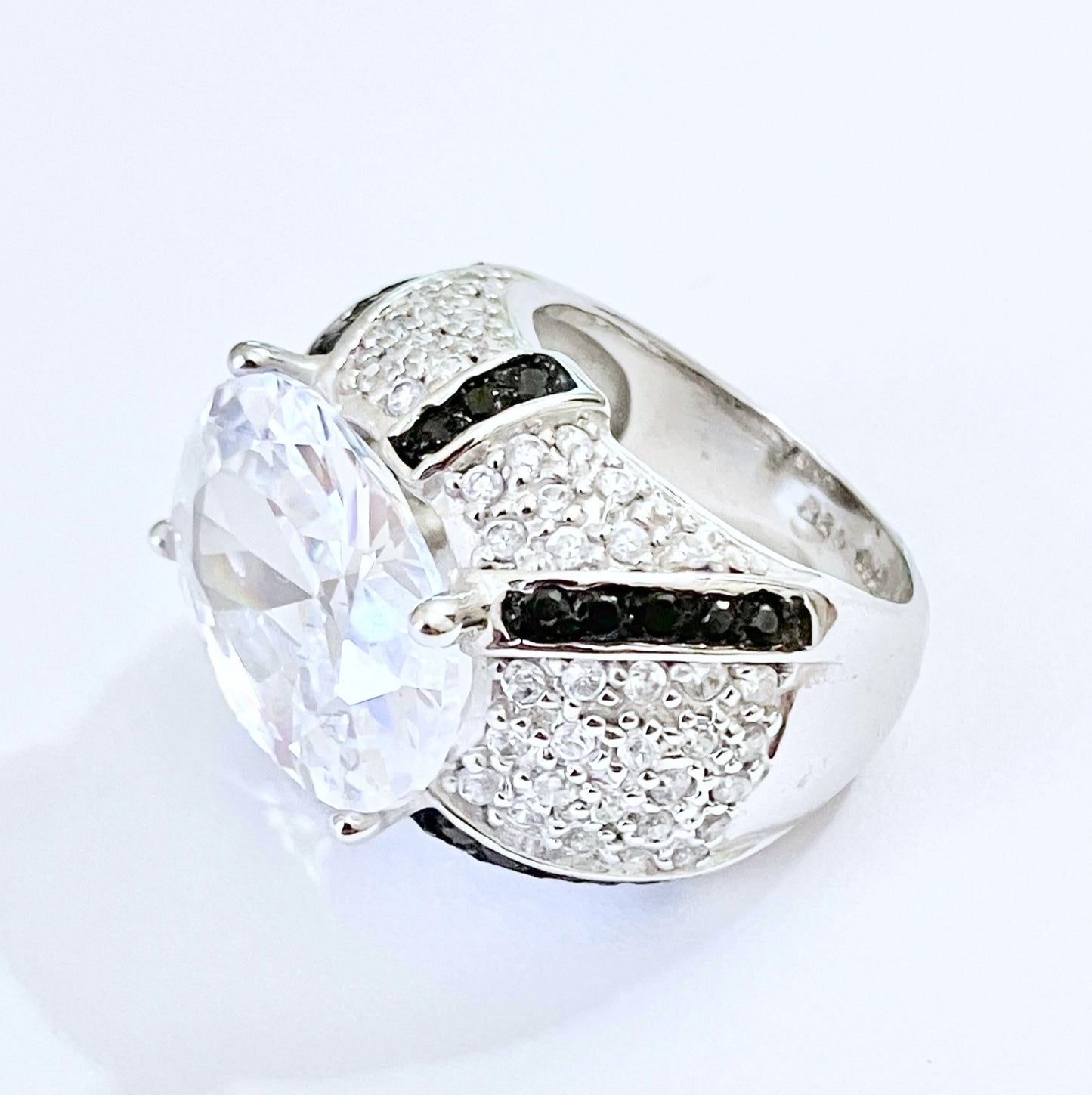 Oval Cut “Diamond” in Black and Colorless “Diamond” Dome Setting Ring